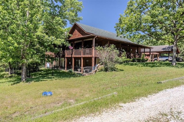 back of property featuring a yard, a carport, and a deck