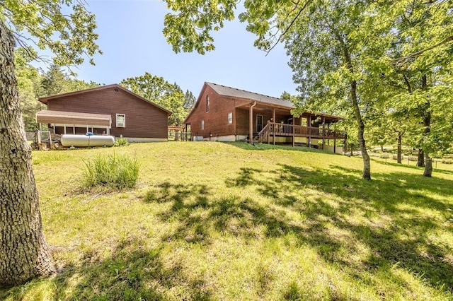 view of green lawn with a deck