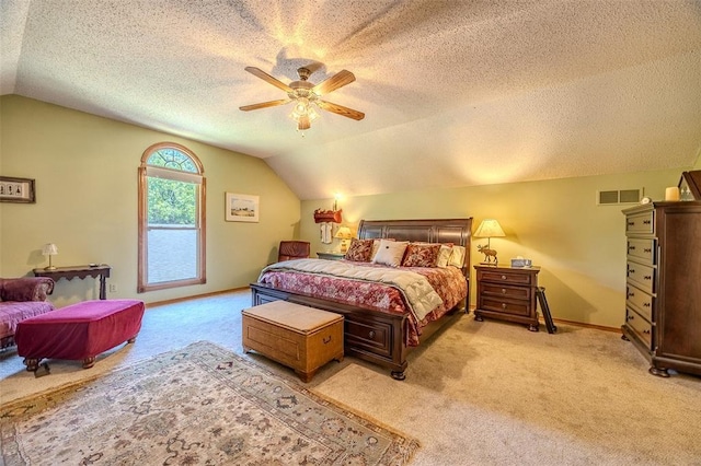 bedroom with light colored carpet, vaulted ceiling, a textured ceiling, ceiling fan, and baseboards