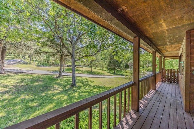 wooden porch featuring a yard
