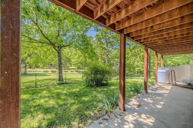 view of yard featuring a patio and view of wooded area