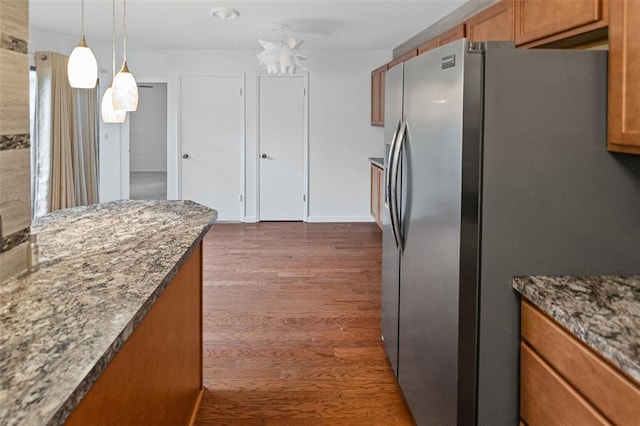 1404 Hampton Ct, Belleville, IL 62223 - kitchen with stainless steel fridge with ice dispenser, brown cabinets, dark wood-style flooring, and stone countertops