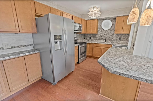 1404 Hampton Ct, Belleville, IL 62223 - kitchen with stainless steel appliances, light wood finished floors, a sink, backsplash, and light stone countertops