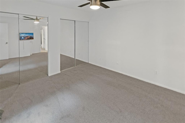 1404 Hampton Ct, Belleville, IL 62223 - unfurnished bedroom featuring multiple closets, carpet floors, a ceiling fan, and baseboards