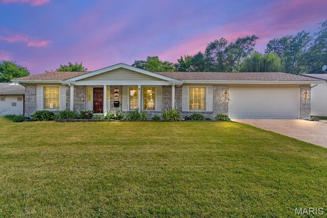 636 Coach House Dr, Hazelwood, MO 63042 - ranch-style house featuring an attached garage, brick siding, concrete driveway, a front yard, and covered porch