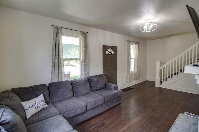 210 W Elm St, Alton, IL 62002 - living room featuring stairs, dark wood-style floors, a chandelier, and baseboards