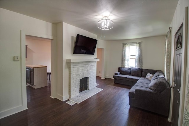 210 W Elm St, Alton, IL 62002 - living area featuring a fireplace, dark wood finished floors, a chandelier, and baseboards