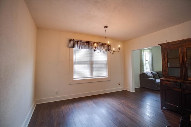 210 W Elm St, Alton, IL 62002 - dining area featuring a chandelier, baseboards, and dark wood-style flooring