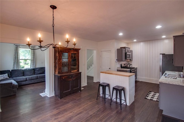 210 W Elm St, Alton, IL 62002 - kitchen with appliances with stainless steel finishes, dark wood-style flooring, a chandelier, baseboards, and butcher block counters
