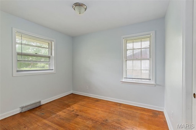 1321 Highmont Dr, Saint Louis, MO 63135 - empty room featuring plenty of natural light and wood finished floors