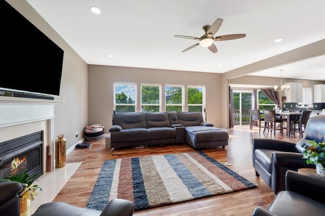 5 The Crossings Ct, Ofallon, MO 63366 - living area featuring a ceiling fan, a premium fireplace, a chandelier, light wood-type flooring, and recessed lighting