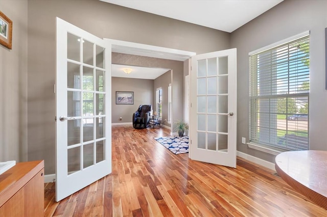 5 The Crossings Ct, Ofallon, MO 63366 - doorway to outside featuring french doors, light wood-style flooring, and baseboards