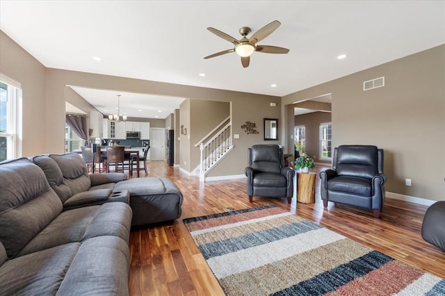 5 The Crossings Ct, Ofallon, MO 63366 - living room with stairs, a chandelier, light wood finished floors, ceiling fan, and recessed lighting