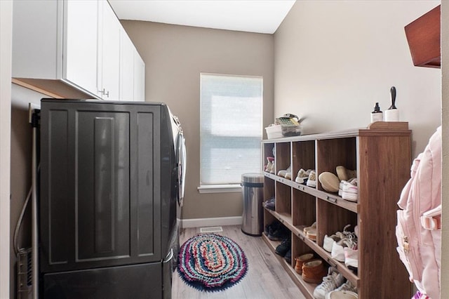 5 The Crossings Ct, Ofallon, MO 63366 - washroom with light wood-style floors, baseboards, and cabinet space