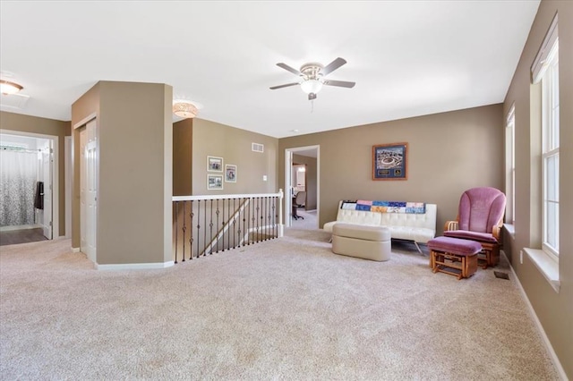 5 The Crossings Ct, Ofallon, MO 63366 - living area with an upstairs landing, carpet, a ceiling fan, and baseboards