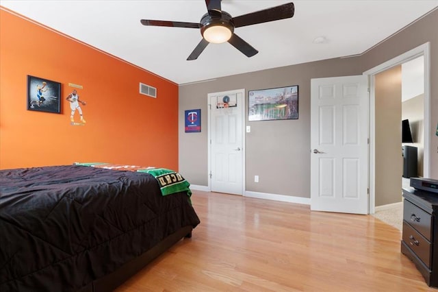 5 The Crossings Ct, Ofallon, MO 63366 - bedroom featuring light wood-style floors, baseboards, ceiling fan, and an accent wall