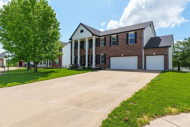 5 The Crossings Ct, Ofallon, MO 63366 - greek revival house featuring driveway, a front yard, brick siding, and an attached garage