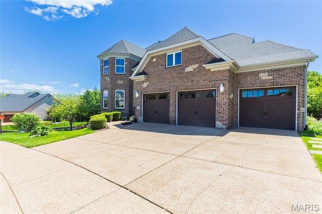 106 Tuscany Trace Dr, Saint Charles, MO 63303 - view of front of home with brick siding, driveway, and roof with shingles