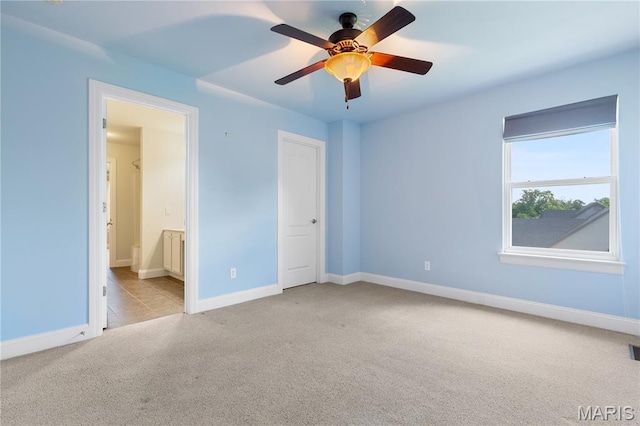 106 Tuscany Trace Dr, Saint Charles, MO 63303 - unfurnished bedroom with carpet flooring, baseboards, ensuite bathroom, and ceiling fan