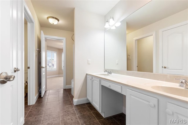 106 Tuscany Trace Dr, Saint Charles, MO 63303 - bathroom featuring toilet, double vanity, baseboards, and tile patterned floors