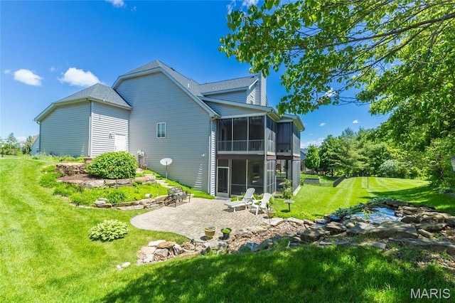 106 Tuscany Trace Dr, Saint Charles, MO 63303 - rear view of house featuring a sunroom, a patio area, and a yard