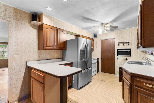 10 Kirby Ln, Belleville, IL 62223 - kitchen featuring a sink, appliances with stainless steel finishes, ceiling fan, light countertops, and wallpapered walls