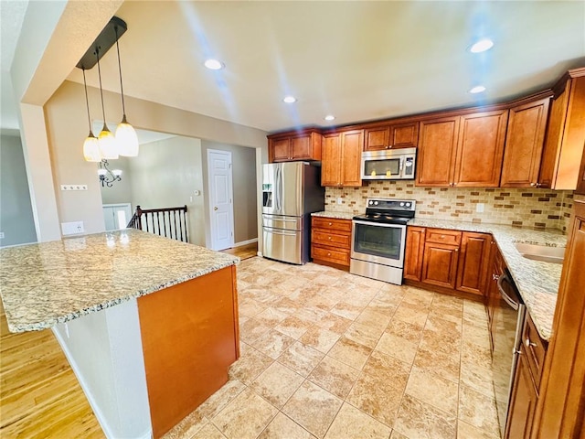 1202 S Mildred Ave, Salem, MO 65560 - kitchen with stainless steel appliances, decorative backsplash, light stone counters, brown cabinetry, and recessed lighting