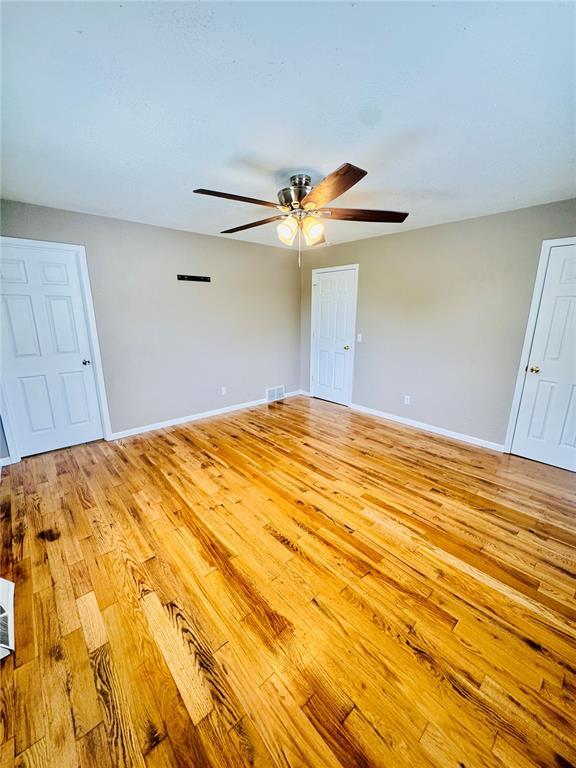 1202 S Mildred Ave, Salem, MO 65560 - empty room featuring light wood-type flooring, ceiling fan, and baseboards