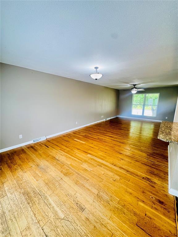 1202 S Mildred Ave, Salem, MO 65560 - spare room featuring light wood finished floors, ceiling fan, and baseboards