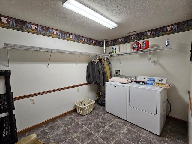 103 E Broad St, Raymond, IL 62560 - laundry room with independent washer and dryer, a textured ceiling, dark tile patterned floors, and baseboards