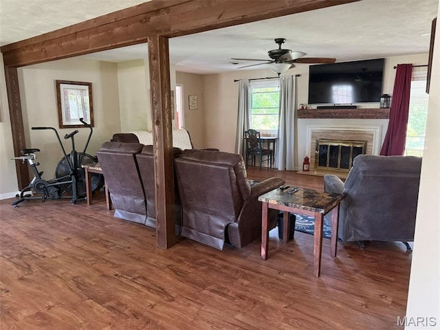 414 Hillcrest Dr, Sullivan, MO 63080 - living area featuring a fireplace, a ceiling fan, beamed ceiling, wood finished floors, and baseboards