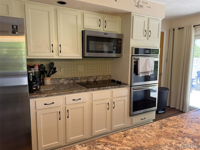 414 Hillcrest Dr, Sullivan, MO 63080 - kitchen with appliances with stainless steel finishes, white cabinets, tasteful backsplash, dark stone counters, and wood finished floors