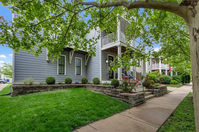 3481 New Town Lake Dr, Saint Charles, MO 63301 - view of front of property with a balcony and a front lawn