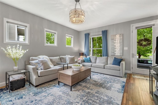 3481 New Town Lake Dr, Saint Charles, MO 63301 - living area featuring a chandelier, hardwood / wood-style floors, and baseboards