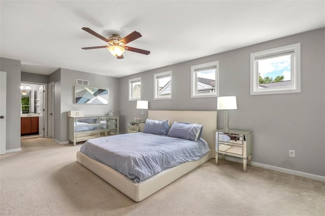 3481 New Town Lake Dr, Saint Charles, MO 63301 - bedroom with light colored carpet, multiple windows, baseboards, and connected bathroom