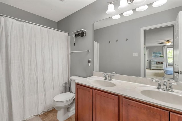 3481 New Town Lake Dr, Saint Charles, MO 63301 - full bath with toilet, double vanity, tile patterned flooring, a shower with shower curtain, and a ceiling fan