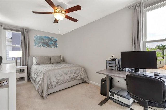 3481 New Town Lake Dr, Saint Charles, MO 63301 - bedroom with an office area, light colored carpet, ceiling fan, and baseboards