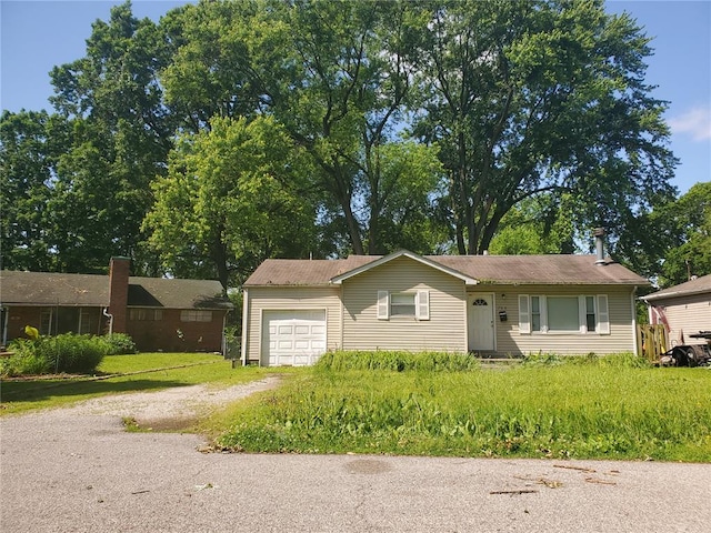 768 Leon St, Cahokia, IL 62206 - ranch-style house with dirt driveway and an attached garage