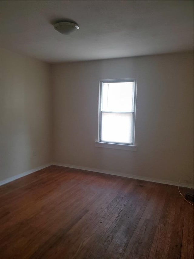 768 Leon St, Cahokia, IL 62206 - empty room with dark wood-style flooring and baseboards