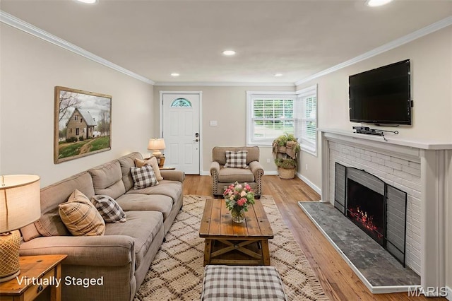 6446 Old Collinsville Rd, Ofallon, IL 62269 - living area featuring a fireplace, recessed lighting, ornamental molding, and light wood-style flooring