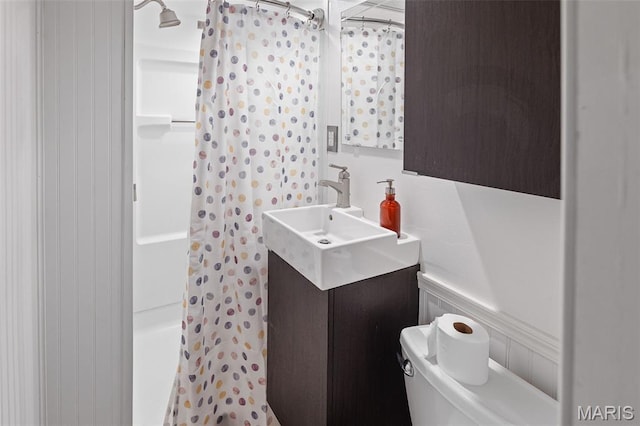 6446 Old Collinsville Rd, Ofallon, IL 62269 - bathroom featuring curtained shower, vanity, and wainscoting