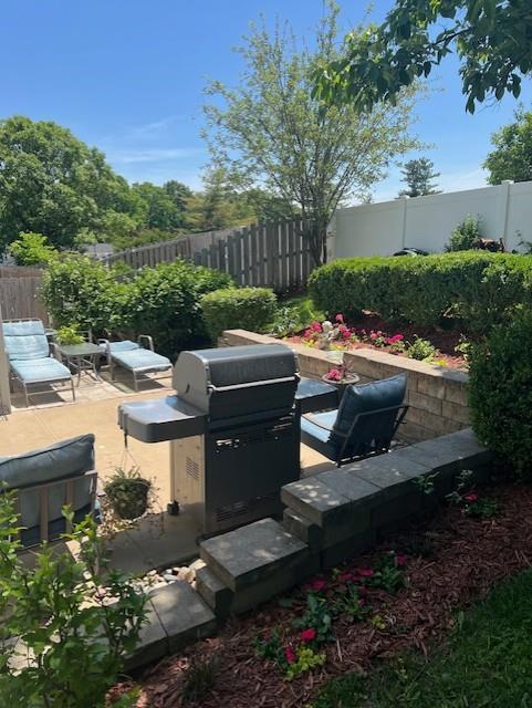341 Fox Village Ct, Ballwin, MO 63021 - view of patio with a fenced backyard and a grill