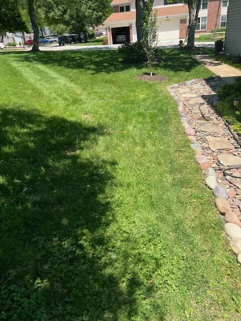 341 Fox Village Ct, Ballwin, MO 63021 - view of grassy yard with a garage