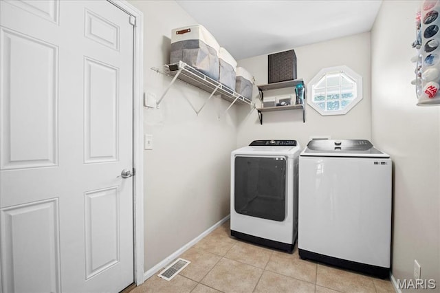 7413 Cinnamon Teal Dr, Ofallon, MO 63368 - laundry room featuring washer and dryer and light tile patterned flooring