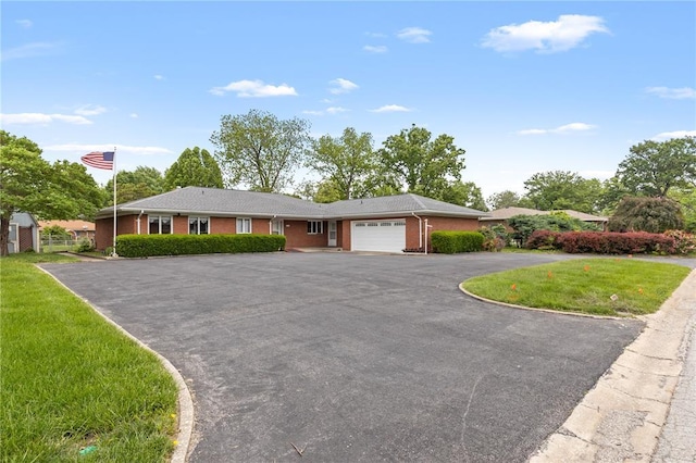 814 Pardee Rd, Godfrey, IL 62035 - ranch-style house with brick siding, an attached garage, asphalt driveway, and a front lawn