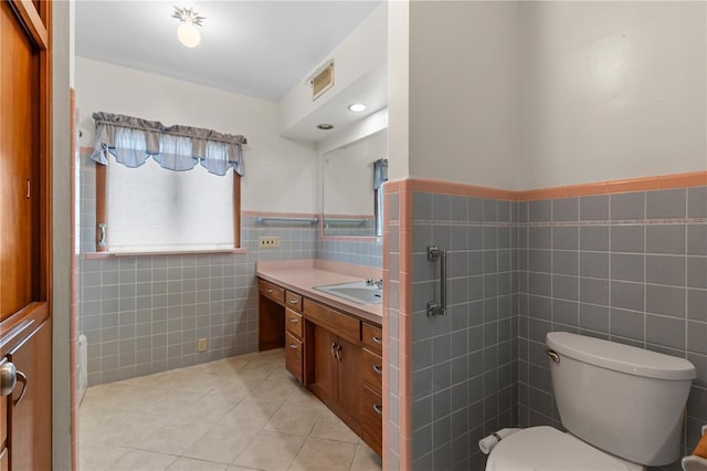 814 Pardee Rd, Godfrey, IL 62035 - bathroom featuring tile walls, vanity, tile patterned flooring, toilet, and wainscoting