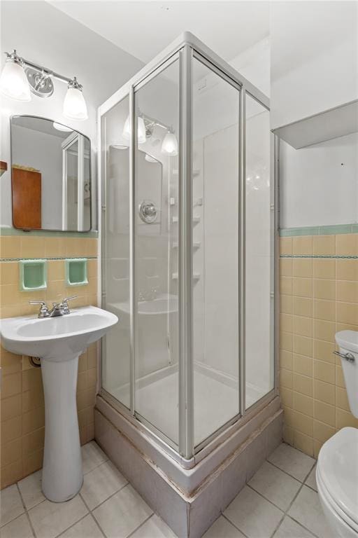 814 Pardee Rd, Godfrey, IL 62035 - bathroom with tile walls, tile patterned floors, toilet, and a stall shower