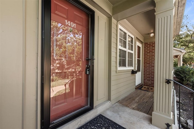 1491 Bobolink Pl, Brentwood, MO 63144 - doorway to property featuring brick siding and covered porch