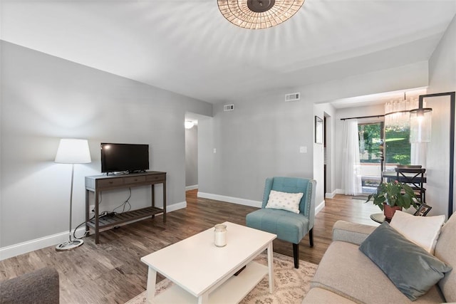 1491 Bobolink Pl, Brentwood, MO 63144 - living room with wood finished floors, baseboards, and a chandelier