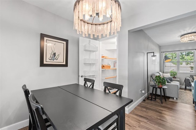 1491 Bobolink Pl, Brentwood, MO 63144 - dining area with a chandelier, baseboards, wood finished floors, and a desk
